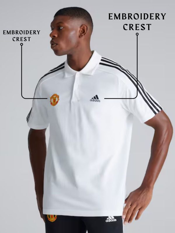 Man wearing a white sports jersey with Adidas and Manchester United logos, labeled 'Embroidery Crest'.